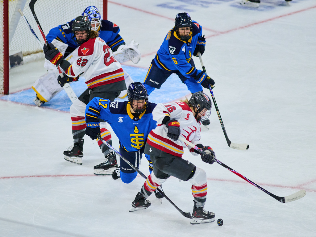 Toronto Sceptres' Ella Shelton (17) and Ottawa Charge's Katerina Mrazova (16) battle for the puck during second period PWHL hockey action in Toronto, on Thursday, Dec. 4, 2025. (Sammy Kogan/The Canadian Press via AP)
