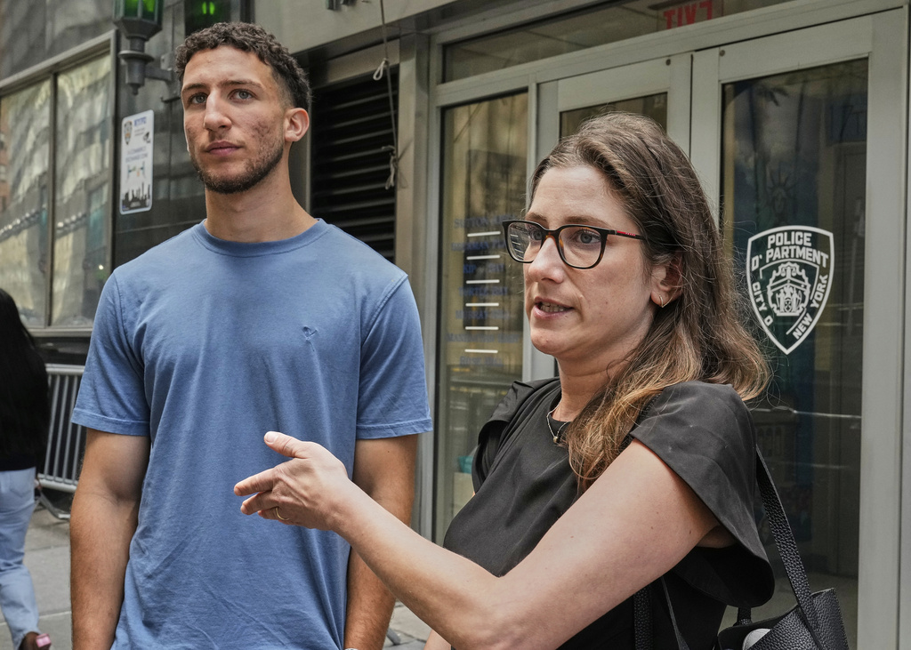 Yasin El Sammak, left, and his attorney Jacqueline Dombroff, are interviewed outside the New York City Police Department's 17th Precinct, Wednesday, Aug. 27, 2025. (AP Photo/Richard Drew)