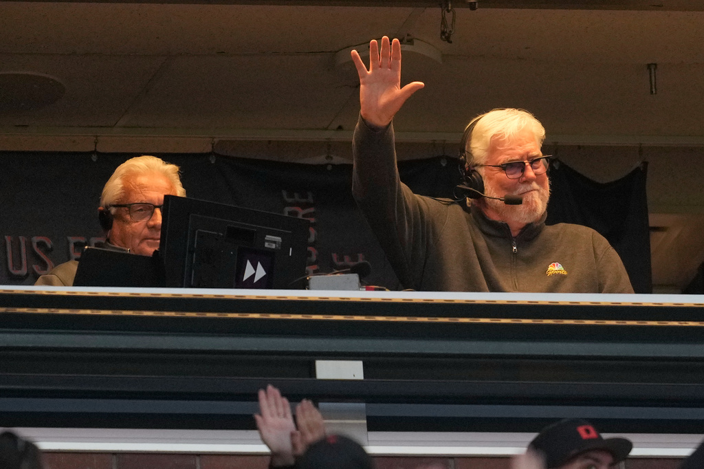 Broadcaster Mike Krukow, right, gestures toward fans next to broadcast partner Duane Kuiper after the second inning of a baseball game between the San Francisco Giants and the Detroit Tigers, Friday, Aug. 7, 2026, in San Francisco. (AP Photo/Jeff Chiu)