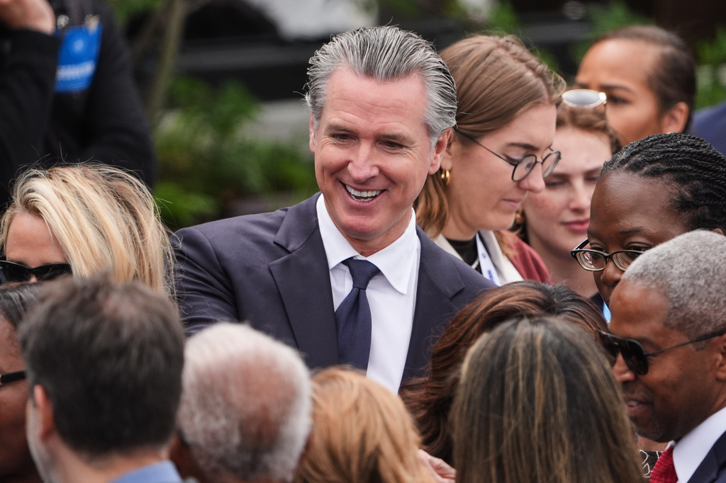 California Gov. Gavin Newsom mingles ahead of the Obama Presidential Center dedication ceremony Thursday, June 18, 2026, in Chicago. (AP Photo/Jeff Roberson)
