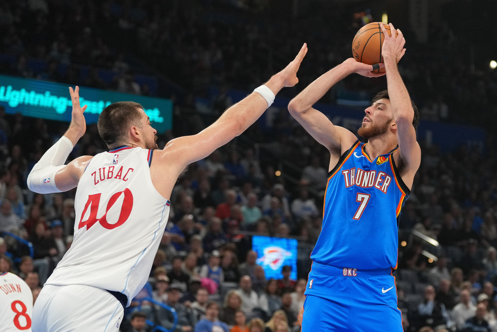 Oklahoma City Thunder center Chet Holmgren (7) looks to shoot over Los Angeles Clippers center Ivica Zubac (40) during the first half of an NBA basketball game, Thursday, Dec. 18, 2025, in Oklahoma City. (AP Photo/Kyle Phillips)