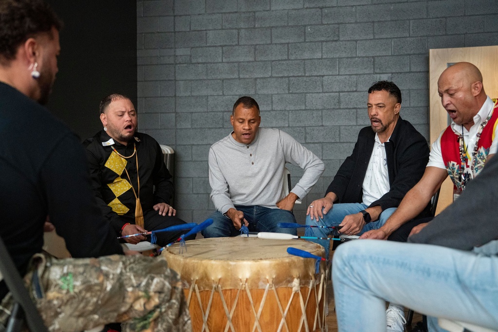 People sing while playing drums during a watch party hosted by the Lumbee Tribe of North Carolina, Wednesday, Dec. 17, 2025, in Pembroke, N.C. (AP Photo/Allison Joyce)