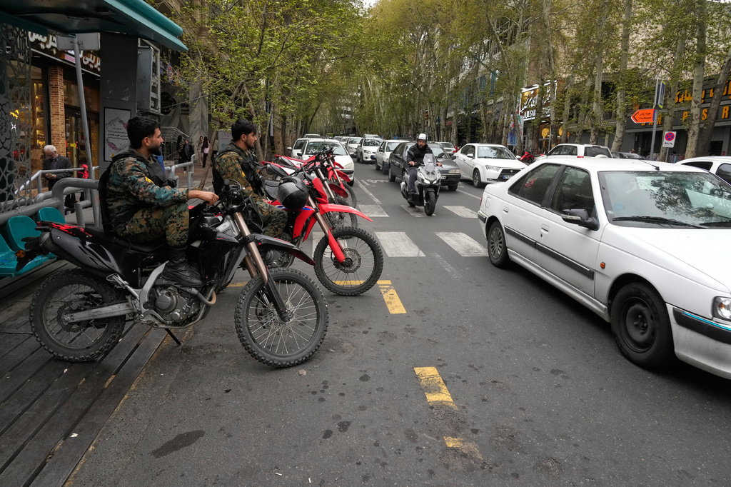Policemen sit on their motorcycles in northern Tehran, Iran, Sunday, April 12, 2026. (AP Photo/Vahid Salemi)