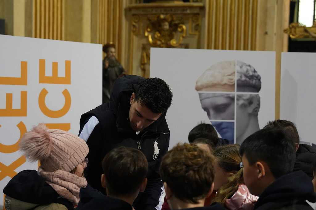 Basketball player Giordano Bertolani speaks to children during a values-focused activity at the Church of Sant’Antonio, part of a church-led initiative tied to the 2026 Winter Olympics, in Milan, Italy, Monday, Feb. 9, 2026. (AP Photo/María Teresa Hernandez)