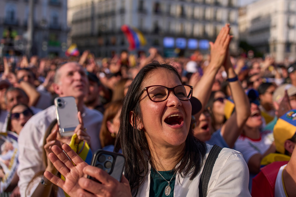 Venezuelan supporters react as Venezuela's opposition leader Maria Corina Machado delivers a speech at Madrid's Puerta del Sol, in Madrid, Spain, Saturday, April 18, 2026. (AP Photo/Manu Fernandez)