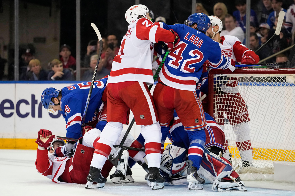 New York Rangers left wing Will Cuylle (50) fights with Detroit Red Wings center Andrew Copp (18), and Rangers center Noah Laba (42) fights with Red Wings left wing James van Riemsdyk (21) during the second period of an NHL hockey game, Saturday, April 4, 2026, in New York. (AP Photo/Yuki Iwamura)