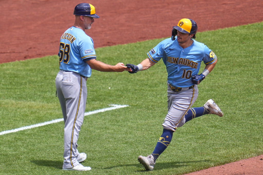 Milwaukee Brewers' Sal Frelick (10) rounds third to greetings from third base coach Matt Erickson (68) after hitting a two-run home run off Pittsburgh Pirates pitcher Braxton Ashcraft during the fifth inning of the first game of a baseball doubleheader in Pittsburgh, Saturday, July 11, 2026. (AP Photo/Gene J. Puskar)