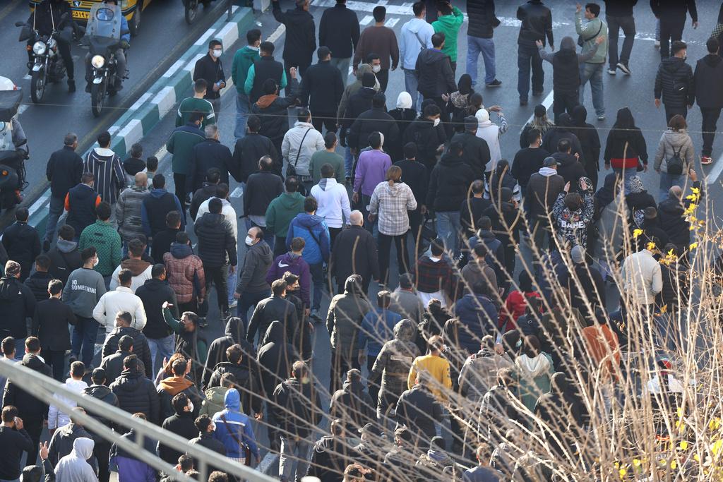 Protesters march in downtown Tehran, Iran, Monday, Dec. 29, 2025. (Fars News Agency via AP)