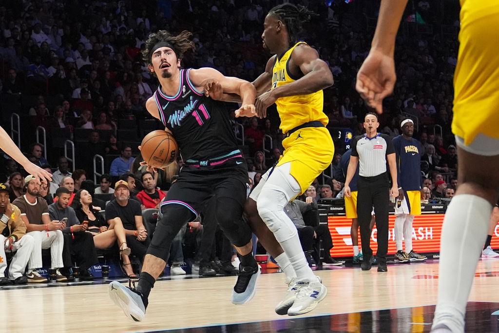Miami Heat forward Jaime Jaquez Jr. (11) drives to the basket as Indiana Pacers guard Aaron Nesmith, right, defends during the first half of an NBA basketball game, Saturday, Dec. 27, 2025, in Miami. (AP Photo/Lynne Sladky)