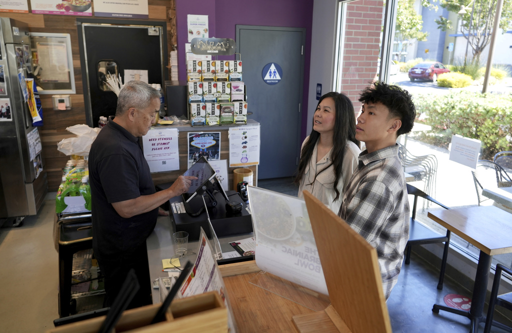 Braxton Kimura, right, orders food with his mother Carol Kimura at Vitality Bowl on Wednesday, Aug. 13, 2025, in San Jose, Calif. (AP Photo/Terry Chea)