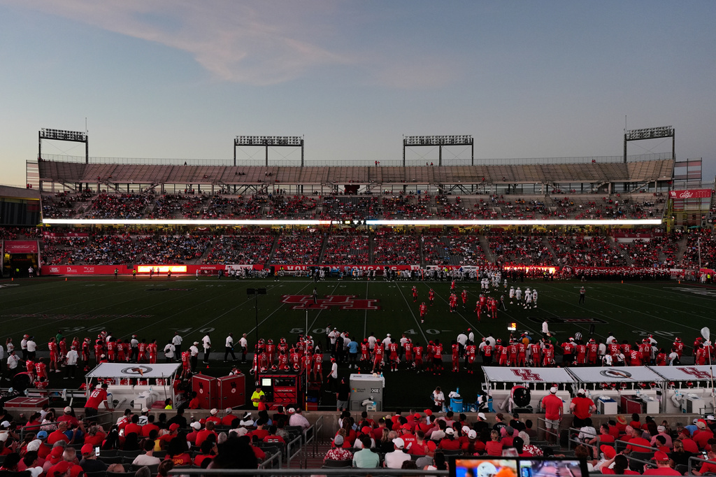 Southern and Houston players continue to play after the stadium lights went out during the first half of their NCAA college football game in Houston, Saturday, Sept. 12, 2026. (AP Photo/Ashley Landis)