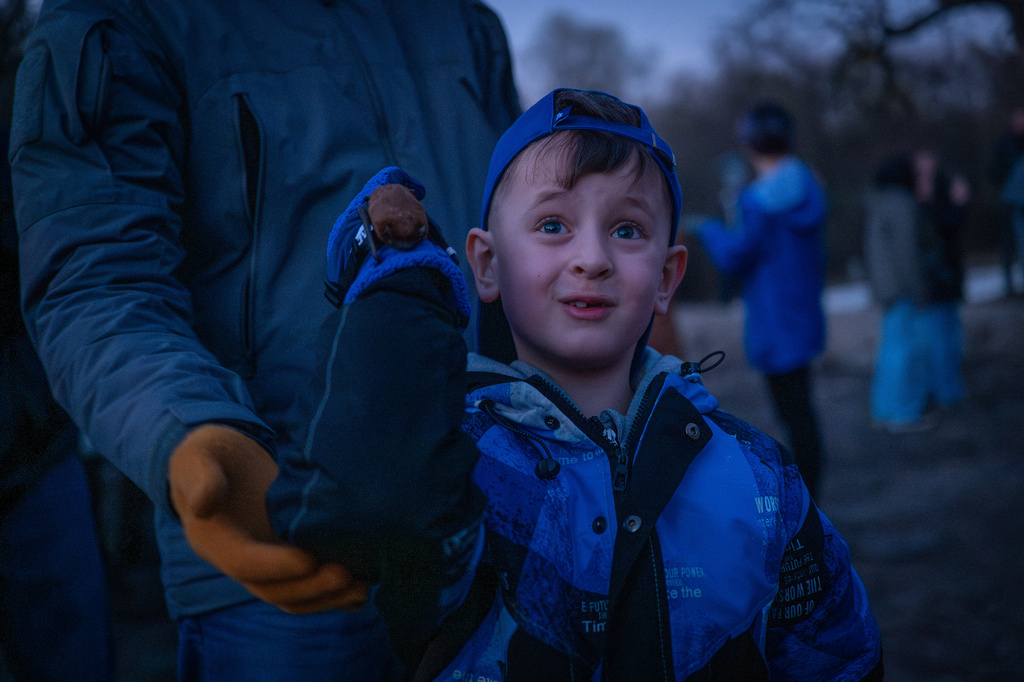 A boy releases a rescued bat during a ceremony of returning bats to the wild in Kyiv, Ukraine, Saturday, April 4, 2026. (AP Photo/Dan Bashakov)