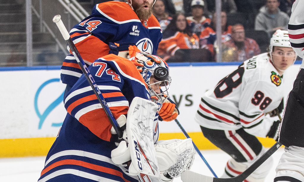 Chicago Blackhawks' Connor Bedard (98) looks back as Edmonton Oilers goalie Stuart Skinner (74) makes the save during first period NHL action, in Edmonton on Saturday, Nov. 1, 2025. (Jason Franson/The Canadian Press via AP)