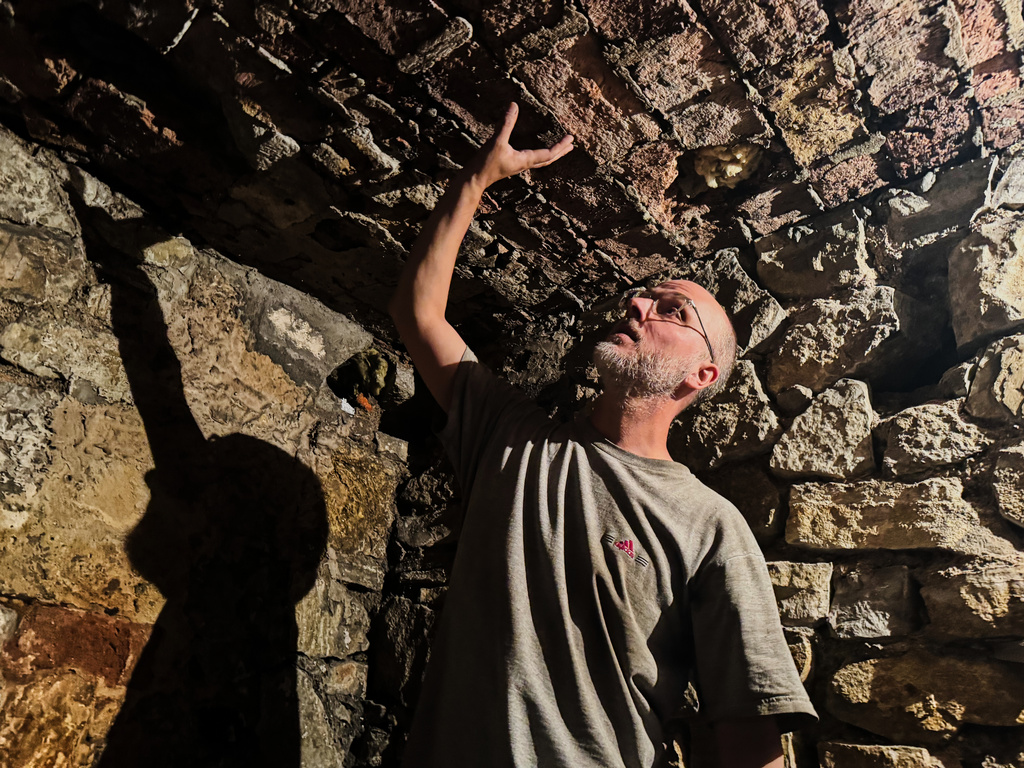 Piotr Jakowenko, president of the Cukerman Gate Foundation, shows entrance to the underground hideout of Jewish residents of the 1943 Ghetto in Bedzin, Poland, on May 29, 2026. (AP Photo/Rafal Niedzielski) CORRECTION: family name corrected to Jakowenko instead of Jakowlenko