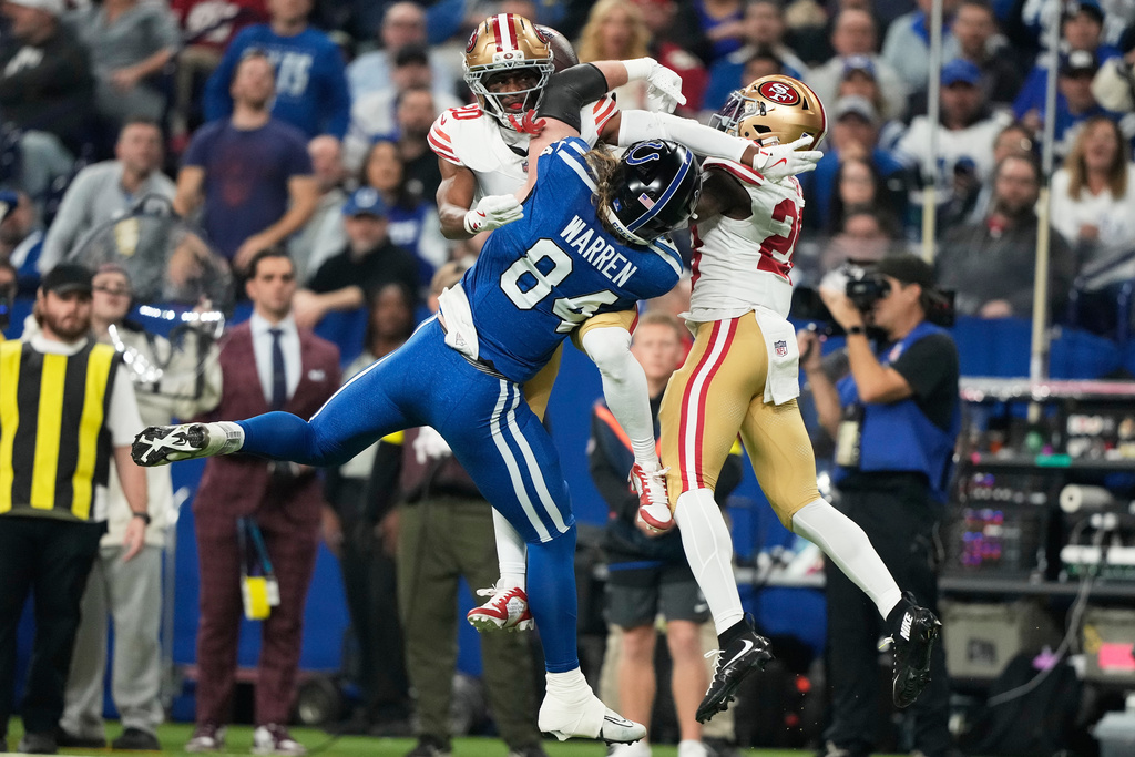 Indianapolis Colts tight end Tyler Warren (84) cannot catch a pass while being defended by San Francisco 49ers cornerback Upton Stout, top left, and cornerback Darrell Luter Jr. during the first half of an NFL football game, Monday, Dec. 22, 2025, in Indianapolis. (AP Photo/Carolyn Kaster)