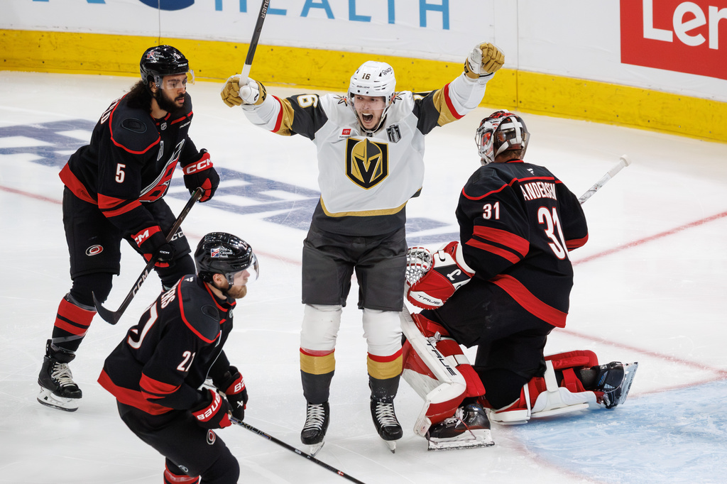 Vegas Golden Knights' Pavel Dorofeyev (16) celebrates between Carolina Hurricanes' Jalen Chatfield (5), Alexander Nikishin (21), and goaltender Frederik Andersen (31) after a goal in the second period of Game 1 of the NHL hockey Stanley Cup Final series in Raleigh, N.C., Tuesday, June 2, 2026. (AP Photo/Ben McKeown)