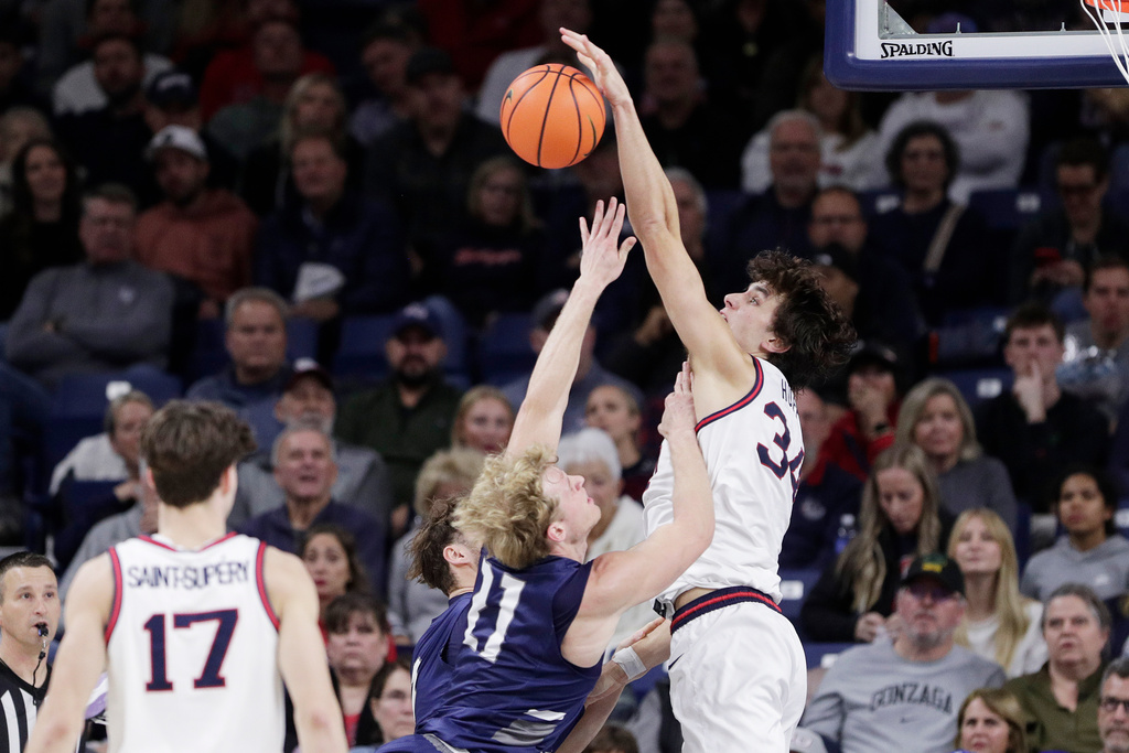 Gonzaga forward Braden Huff, right, blocks a shot by North Florida forward Dalton Gayman (21) during the second half of an NCAA college basketball game, Sunday, Dec. 7, 2025, in Spokane, Wash. (AP Photo/Young Kwak)