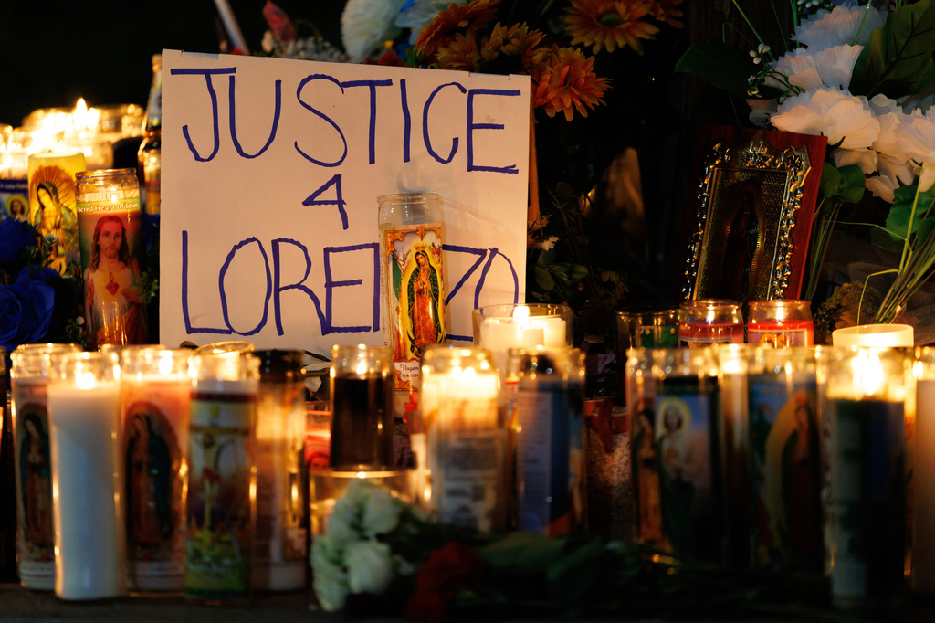Candles are lit during a vigil for Lorenzo Salgado Araujo, a Mexican national fatally shot by a federal immigration agent a day prior, Wednesday, July 8, 2026, in Houston. (AP Photo/Mark Felix)