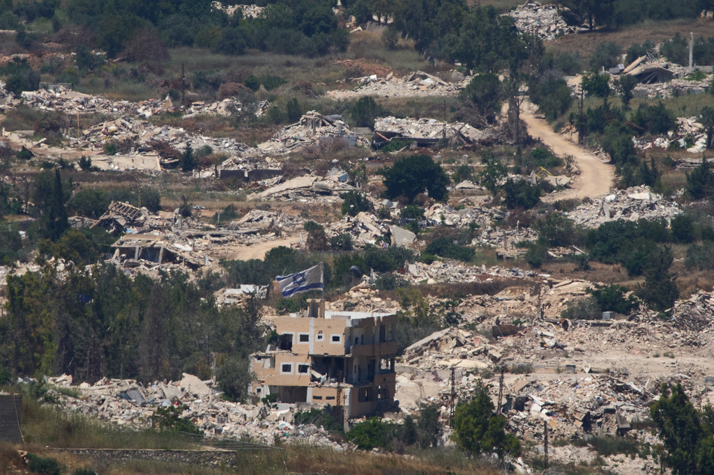 An Israeli flag hangs on a damaged building in southern Lebanon as seen from northern Israel, Wednesday, July 1, 2026. (AP Photo/Ariel Schalit)