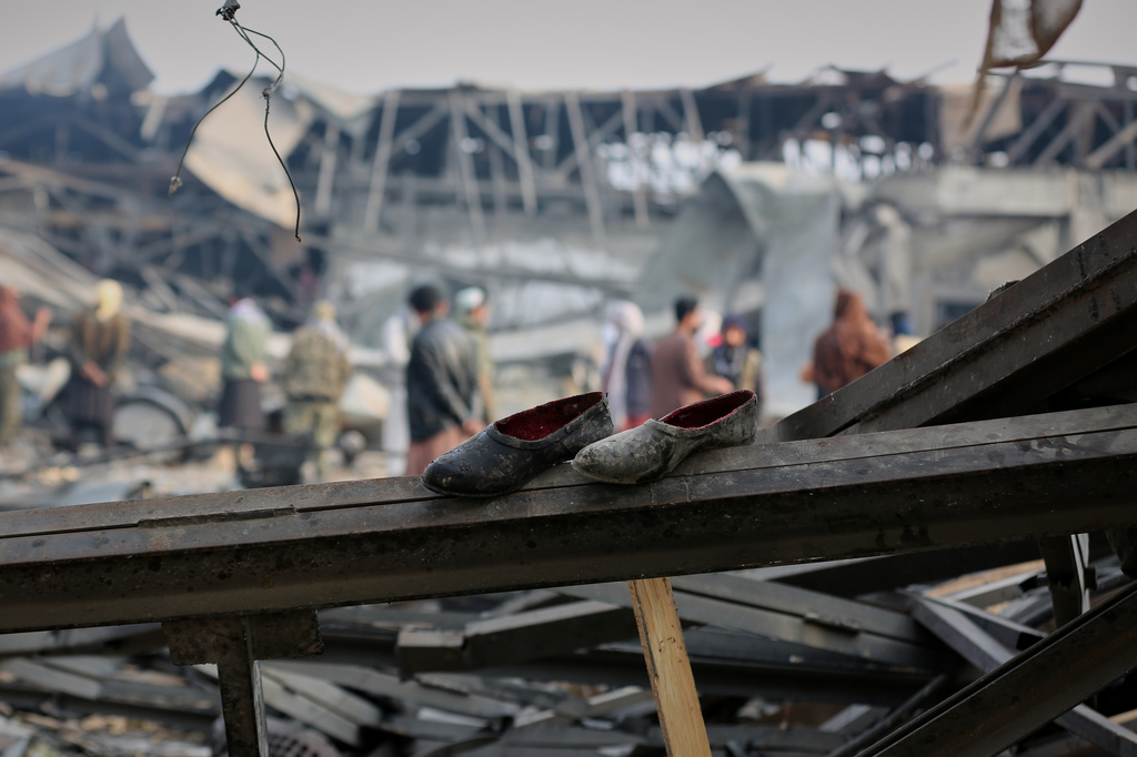 FILE - Residents and rescue workers inspect the site of an airstrike at a drug rehabilitation hospital in Kabul, Afghanistan, March 17, 2026. (AP Photo/Siddiqullah Alizai, File)