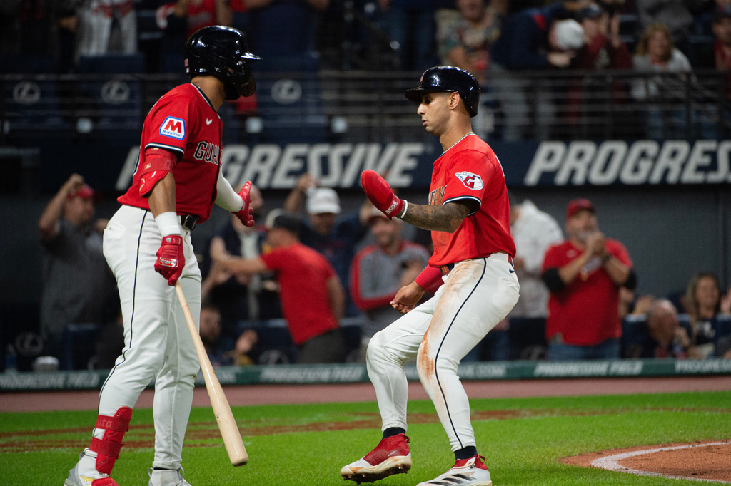 Cleveland Guardians' Brayan Rocchio, right, is congratulated by George Valera after scoring on an RBI single by Steven Kwan during the fifth inning of a baseball game against the Detroit Tigers, Wednesday, Sept. 24, 2025, in Cleveland. (AP Photo/Phil Long)