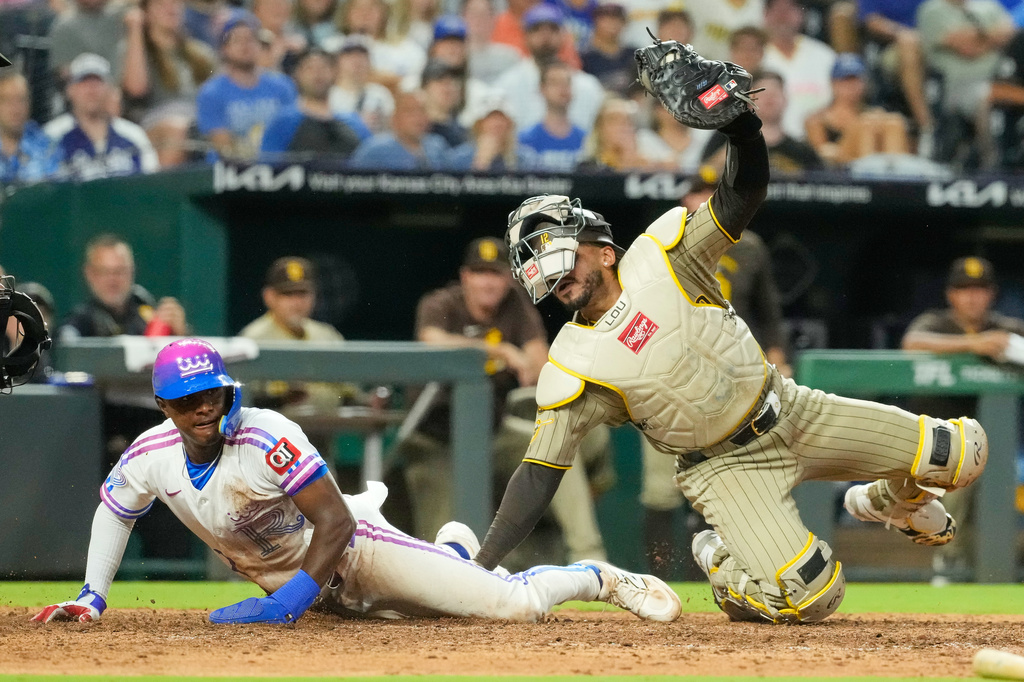 Kansas City Royals' Tyler Tolbert is tagged out at home by San Diego Padres catcher Luis Campusano as he tried to score on a fielder's choice hit into by Kansas City Royals' Vinnie Pasquantino during the eighth inning of a baseball game Friday, July 17, 2026, in Kansas City, Mo. (AP Photo/Charlie Riedel)