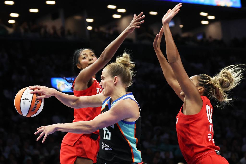 New York Liberty forward Leonie Fiebich, center, passes the ball against Atlanta Dream forwards Angel Reese, left, and Naz Hillmon, right, during the first half of Game 3 of the WNBA basketball semifinals, Friday, Oct. 9, 2026, in New York. (AP Photo/Heather Khalifa)