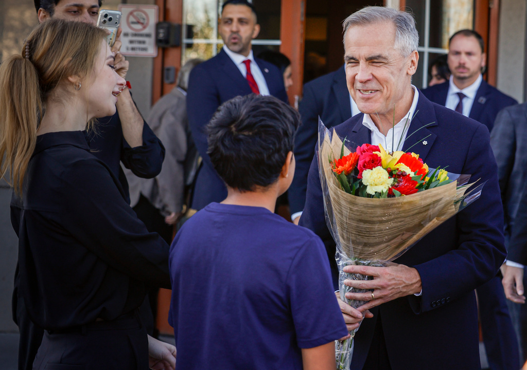 Canada Prime Minister Mark Carney, right, meets with supporters at a restaurant in Calgary, Canada, Thursday, Oct. 15, 2026. (Jeff McIntosh/The Canadian Press via AP)