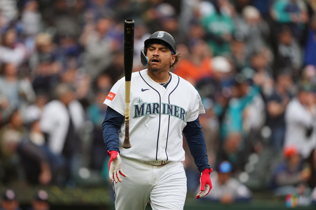 Seattle Mariners' Josh Naylor flips his bat after hitting his second home run of the game, a two-run home run during the third inning of a baseball game against the Houston Astros, Monday, April 13, 2026, in Seattle. (AP Photo/Lindsey Wasson)