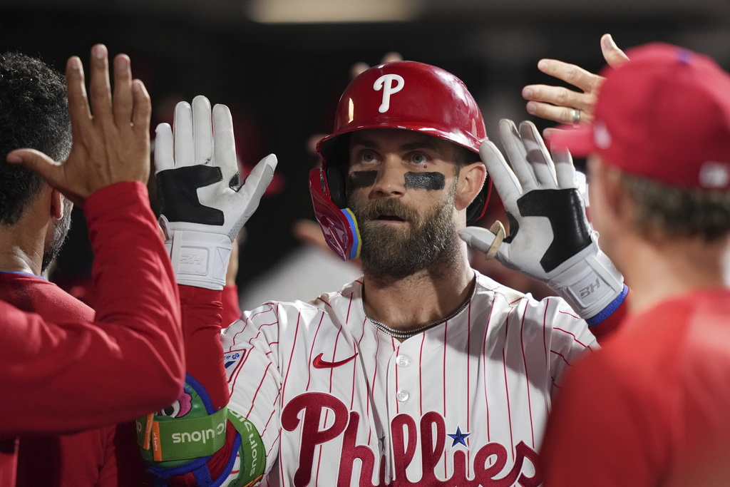 Philadelphia Phillies' Bryce Harper celebrates with teammates after hitting a two-run home run against Seattle Mariners pitcher Casey Legumina during the seventh inning of a baseball game Monday, Aug. 18, 2025, in Philadelphia. (AP Photo/Matt Slocum)