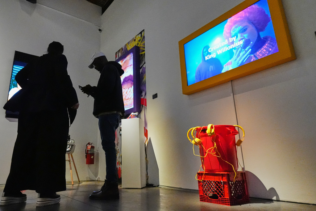 Willonius Hatcher, also known as King Willonius, talks to people during the a16z AI Creative Gallery, Thursday, Sept. 18, 2025, in New York. (AP Photo/Frank Franklin II)