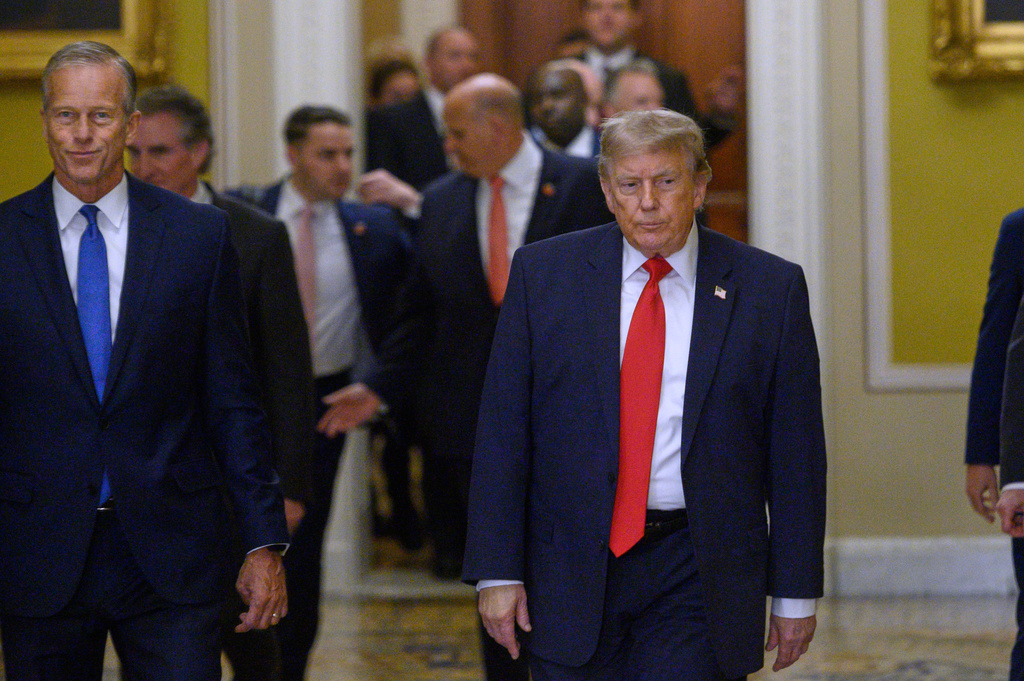 President Donald Trump walks with Senate Majority Leader John Thune, R-S.D., left, before a Senate Republican lunch at the U.S. Capitol, in Washington, Wednesday, June 24, 2026. (AP Photo/Cliff Owen)