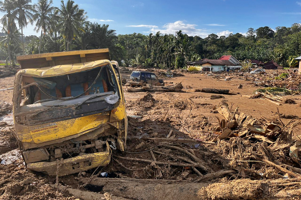 Wreckages of vehicles litter a village affected by a flash flood in Agam, West Sumatra, Indonesia, Monday, Dec. 1, 2025. (AP Photo/Ade Yuandha)