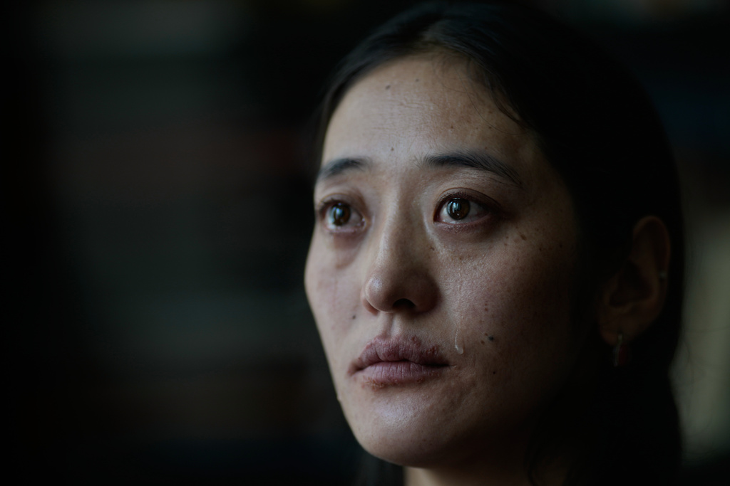 A tear rolls down the cheek of Namkyi, a Tibetan former political prisoner who was arrested at 15 an imprisoned for protesting Chinese rule, as she recounts her story during an interview at the Office of Tibet in Washington, Oct. 8, 2025. (AP Photo/David Goldman)