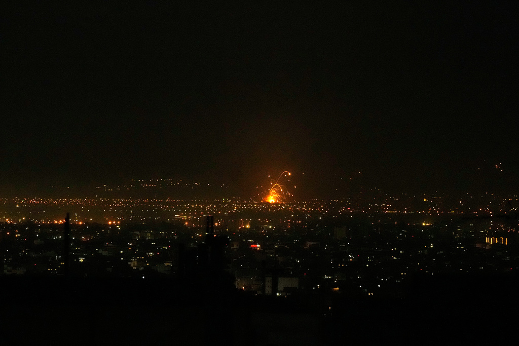 An explosion is seen in Tehran, Iran, Sunday, March 1, 2026. (AP Photo/Vahid Salemi)