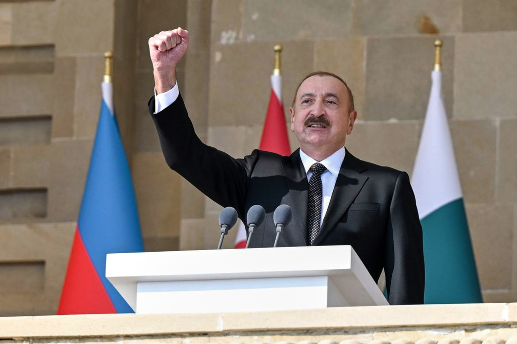 In this photo provided by Azerbaijan's Presidential Press Service, Azebaijan's President Ilham Aliyev gestures during a military parade in Baku, on Saturday, Nov. 8, 2025, while celebrating the fifth anniversary of the victory in the Nagorno-Karabakh war after Azerbaijan gained the full control over the separatist region. (Azerbaijan's Presidential Press Service via AP)