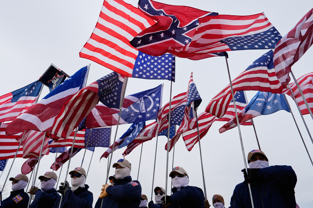 A member of the Patriot Front holds a Confederate flag on the National Mall during the annual March for Life, Friday, Jan. 23, 2026, in Washington. (AP Photo/Julia Demaree Nikhinson)