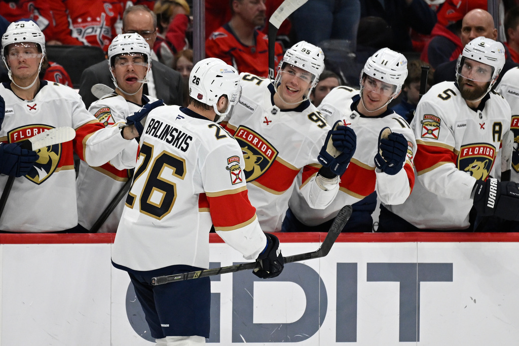 Florida Panthers defenseman Uvis Balinskis (26) is congratulated by teammates after scoring a goal during the second period of an NHL hockey game against the Washington Capitals, Saturday, Jan. 17, 2026, in Washington. (AP Photo/John McDonnell)