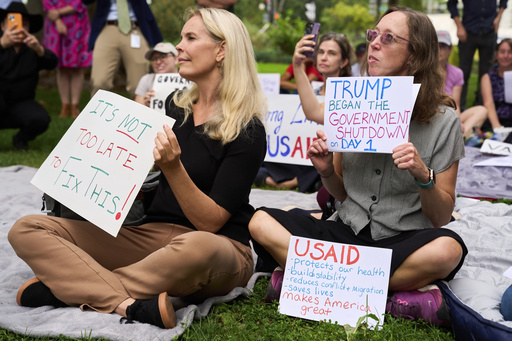 Layne Morrison, left, of Washington, and Courtney Creek, of Silver Spring, Md., who were let go from their jobs with the Education Department and a USAID funded grant respectively, hold signs about the looming government shut down, Tuesday, Sept. 30, 2025, on Capitol Hill in Washington, during a rally with former federal employees. (AP Photo/Jacquelyn Martin) Layne Morrison, left, of Washington, and Courtney Creek, of Silver Spring, Md., who were let go from their jobs with the Education Department and a USAID funded grant respectively, hold signs about the looming government shut down, Tuesday, Sept. 30, 2025, on Capitol Hill in Washington, during a rally with former federal employees. (AP Photo/Jacquelyn Martin)