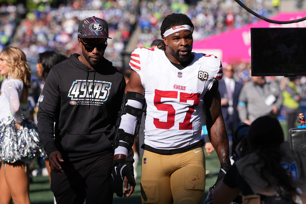 San Francisco 49ers linebacker Dre Greenlaw (57) leaves the field after being ejected during the first half of an NFL football game against the Seattle Seahawks, Sunday, Oct. 11, 2026, in Seattle. (AP Photo/Lindsey Wasson)
