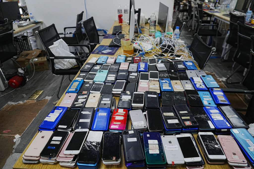 FILE - Equipment confiscated in a raid by Cambodian police are laid out on a table at a scam center in Phnom Penh, Cambodia, Wednesday, March 11, 2026. (AP Photo/Heng Sinith, file)