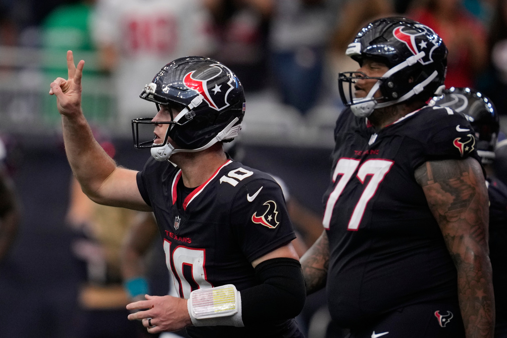 Houston Texans quarterback Davis Mills (10) celebrates a touchdown with teammates during the second half of an NFL football game against the Jacksonville Jaguars, Sunday, Nov. 9, 2025, in Houston. (AP Photo/Ashley Landis)