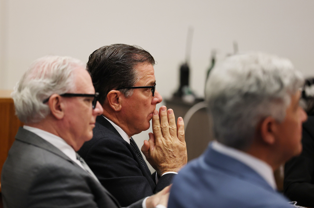 John Carpino, center, president of the Los Angeles Angels, sits with Kevin Dorse, left, and Todd Theodora as they wait for a verdict in the wrongful death lawsuit by the family of pitcher Tyler Skaggs against the Los Angeles Angels in Orange County Superior Court in Santa Ana, Calif., Friday, Dec. 19, 2025. (Allen J. Schaben/Los Angeles Times via AP, Pool)