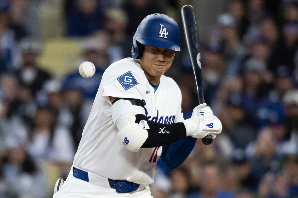 Los Angeles Dodgers' Shohei Ohtani is hit by a pitch during the first inning of a baseball game against the New York Mets in Los Angeles, Monday, April 13, 2026. (AP Photo/Kyusung Gong)