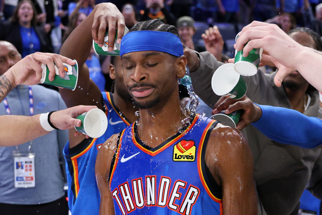 Oklahoma City Thunder players pour water on Thunder guard Shai Gilgeous-Alexander after an NBA basketball game against the Boston Celtics, Thursday, March 12, 2026, in Oklahoma City. (AP Photo/Nate Billings)