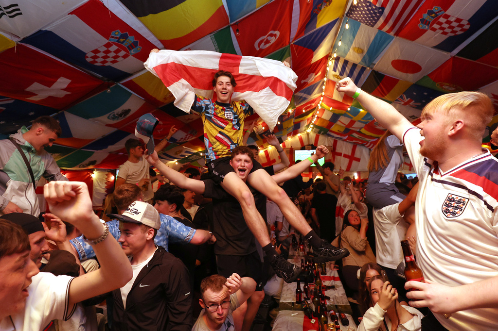 England supporters celebrate during a screening of the World Cup soccer match between England and Croatia at The Clock pub in Hebburn, England, Wednesday, June 17, 2026. (AP Photo/Scott Heppell)