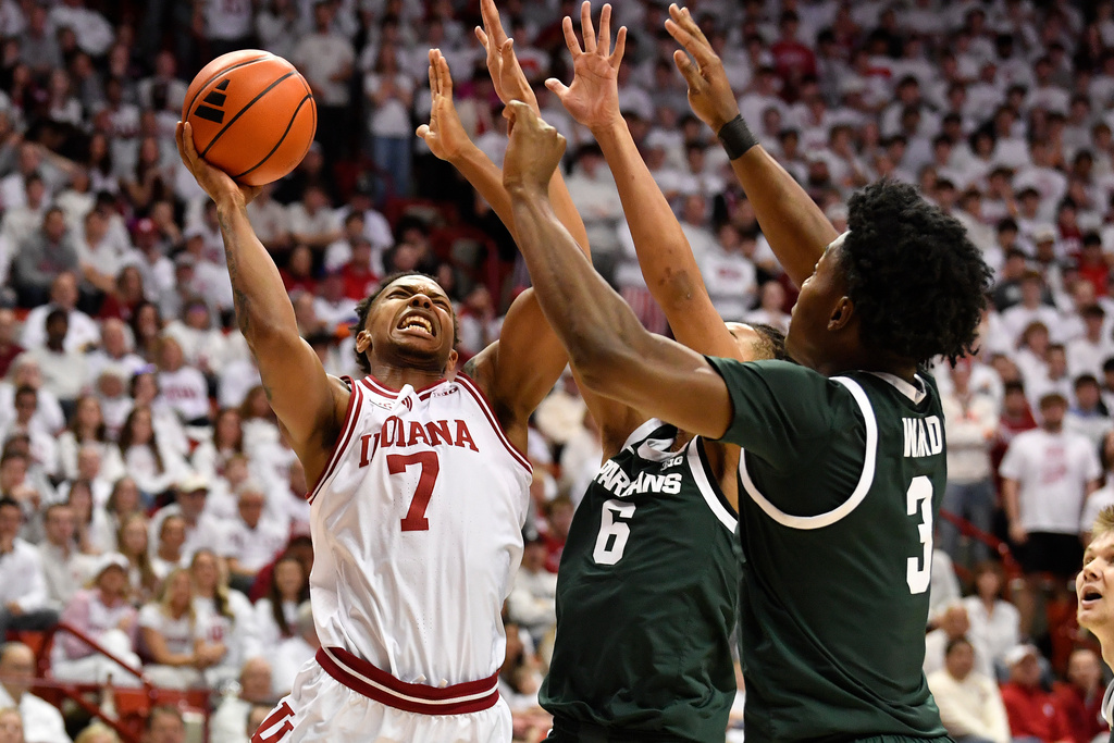 Indiana forward Nick Dorn (7) shoots over Michigan State forward Jordan Scott (6), and forward Cameron Ward (3) during the second half of an NCAA college basketball game in Bloomington, In., Sunday, March 1, 2026. (AP Photo/Timothy D. Easley)