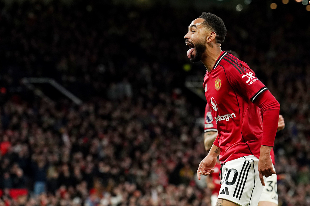 Manchester United's Matheus Cunha celebrates scoring the opening goal during the English Premier League soccer match between Manchester United and Brighton & Hove Albion in Manchester, England, Saturday, Oct. 25, 2025. (Martin Rickett/PA via AP)