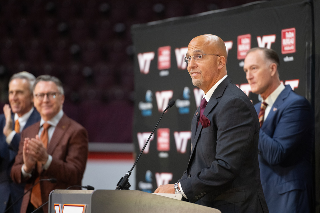 James Franklin, Virginia Tech's new head football coach, is introduced during an NCAA college football news conference, Wednesday, Nov. 19, 2025, in Blacksburg, Va. At left is Athletic Director Whit Babcock, (AP Photo/Robert Simmons)