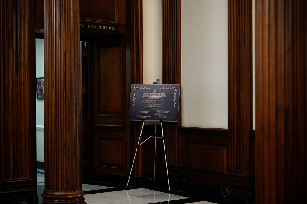 A replica plaque commemorating the Jan. 6, 2021 Capitol riot stands outside the office of House Minority Leader Hakeem Jeffries, D-N.Y, Tuesday, Dec. 30, 2025, at the U.S. Capitol in Washington. (AP Photo/Julia Demaree Nikhinson)